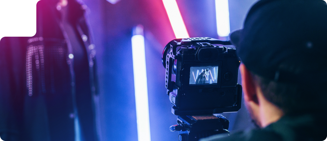 Photographer capturing a model with cinematic lighting and vibrant colors, showcasing ROC Media's photography services for impactful brand visuals.
