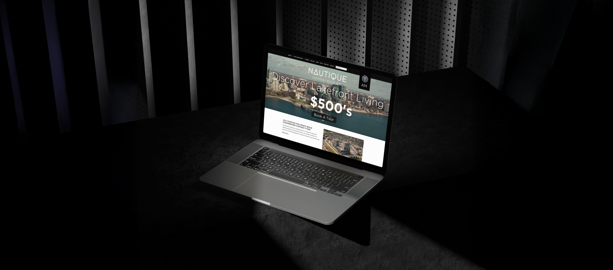 Laptop displaying the Nautique Lakefront Residences website, featuring promotional text about waterfront living and lead generation for Adi Developments, set against a dark background with dramatic lighting.