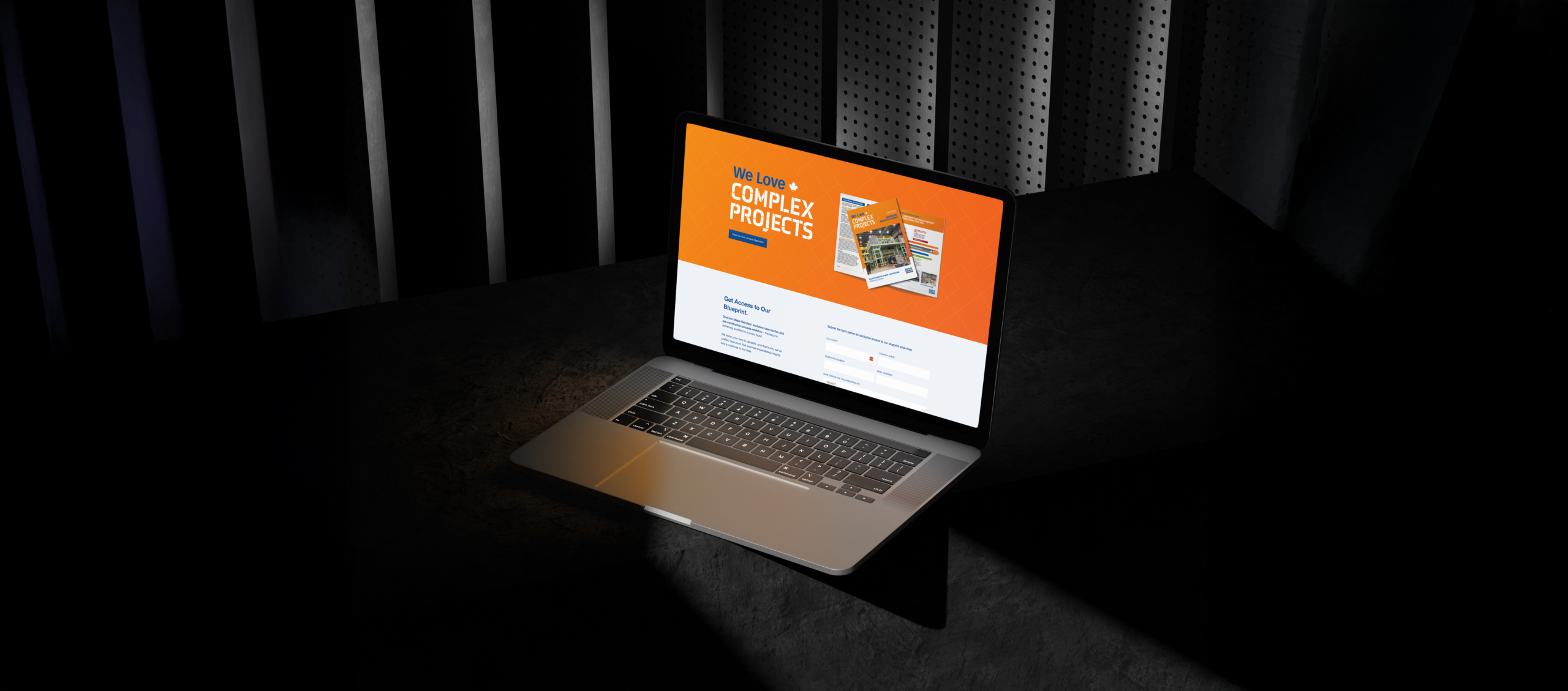 Laptop displaying the "We Love Complex Projects" landing page for Maple Reinders, featuring an orange background, project visuals, and a call-to-action form, symbolizing innovative construction solutions.