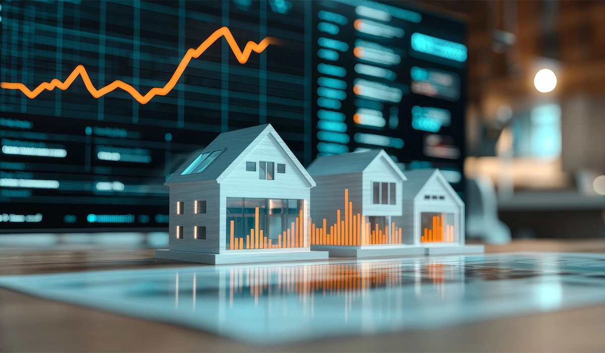 Model houses with growth charts in front of a digital screen, representing integrated marketing strategies in real estate sales and construction.