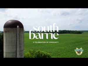 South Barrie community landscape featuring a silos and lush green fields, with text overlay "south barrie" and "A CELEBRATION OF COMMUNITY," reflecting ROC Media's partnership with Remington Homes.