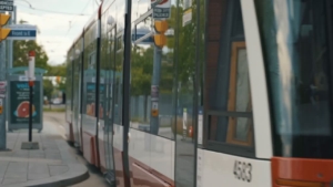Tram at a stop in the Canary District, showcasing urban transit infrastructure and community engagement for ROC Media's marketing initiatives.