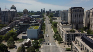 Aerial view of Bayview Village showcasing urban skyline, modern buildings, and tree-lined streets, highlighting the vibrant community and architectural design.