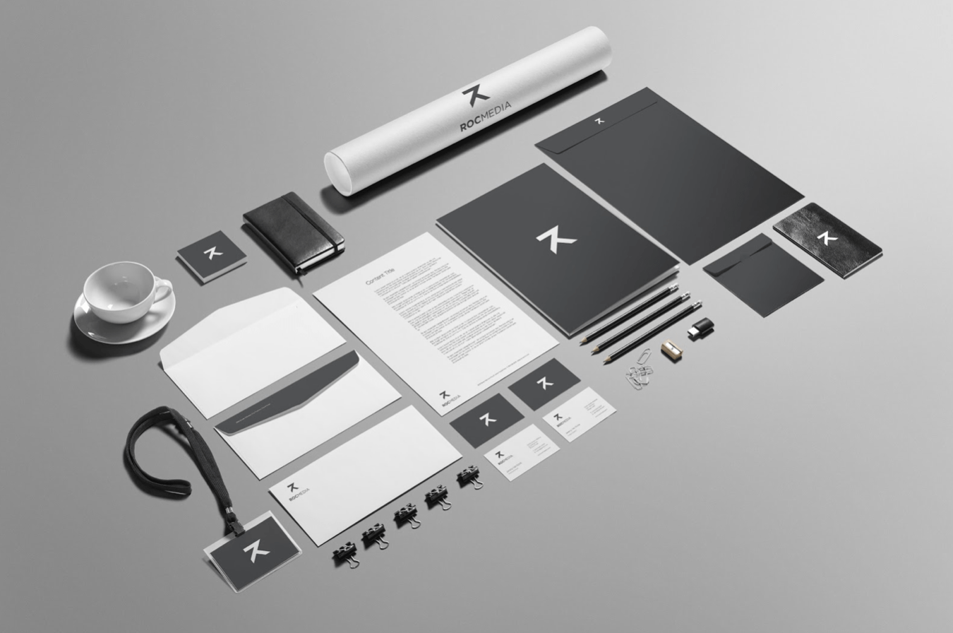 Visual identity branding elements for ROC Media Inc., including business cards, stationery, a notebook, and a coffee cup, emphasizing a cohesive design theme.